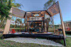 a tiny house with a glass door on a deck at Shabbat Hotel Boutique in San Vicente