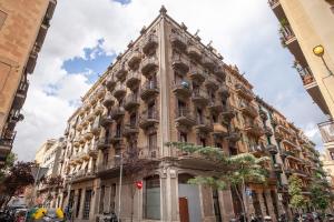 a large building in the middle of a street at Modern and bright 4BD triplex in Paralel! in Barcelona