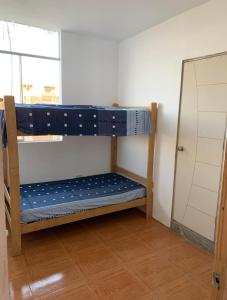 a bunk bed in a room with a mirror at Sand house in Máncora