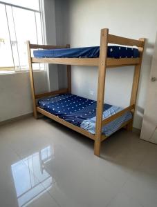 two bunk beds in a room with a window at Sand house in Máncora