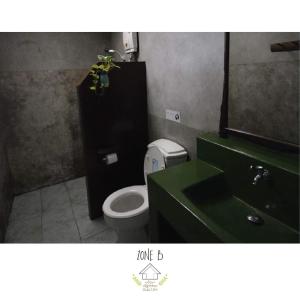 a bathroom with a toilet and a green sink at บ้านณัฐวรรณ หัวหิน Zone B - Baan Nattawan Huahin Zone B in Hua Hin