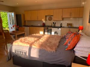 a bedroom with a bed with a furry rug on it at Neema in Barnstaple