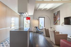 a living room with a dining table and chairs at 3-bedroom penthouse with terrace in Eixample in Barcelona