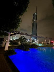 a view of a building with blue lights at night at Casa Residency in Kuala Lumpur