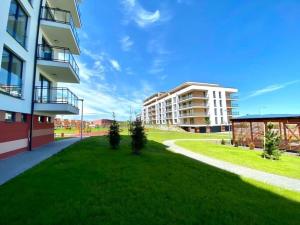 a green lawn in front of a building at Luxury penthouse with Kosice view in Košice