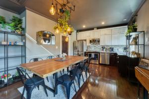 a kitchen and dining room with a wooden table and chairs at Movie Lover's Gem - Steps from Metro & the Capitol! in Washington