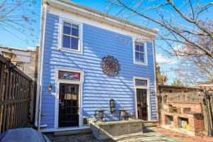 a blue house with two chairs on the porch at Movie Lover's Gem - Steps from Metro & the Capitol! in Washington, D.C.