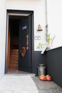 a black door with a heart sign on it at Casa Vila Rosa in Peso da Régua
