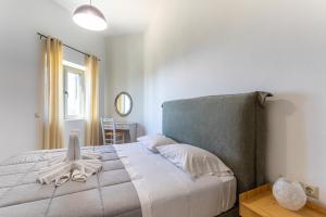 a bedroom with a bed and a table and a window at Villa Daniela in Neokhórion