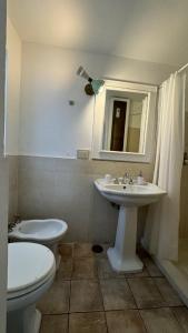 uma casa de banho com um lavatório, um WC e um espelho. em Suites Edivino Design Capri em Capri