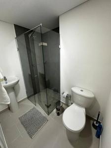 a bathroom with a toilet and a glass shower at Apartaestudio tipo loft nuevo in Medellín