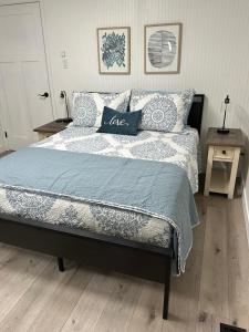 a bedroom with a bed with a blue and white comforter at 2BR Gem: Modern Comfort & Style in Cheyenne