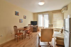 a kitchen and living room with a table and chairs at Central Area Retreat AC & WiFi in Varna City