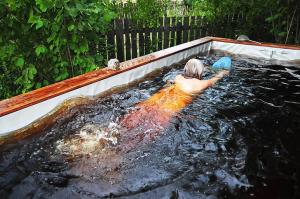 a man swimming in a pool of water at Grenlanda in Ulanów