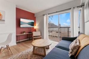 a living room with a couch and a table at Okanagan Lakefront Resort in Penticton