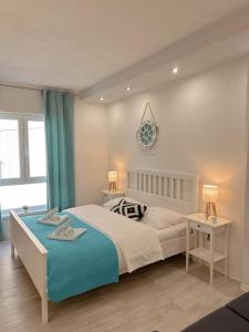 a bedroom with a large bed with a blue blanket at Anamari Apartments in Zadar +18 photos