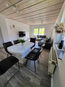 sala de estar con mesa blanca y sillas en Ferienwohnung mit ruhiger Lage, en Hilchenbach