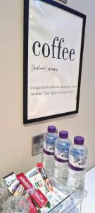 a shelf with bottles of water and a sign on a wall at Stylish & modern studio in Burnley in Burnley