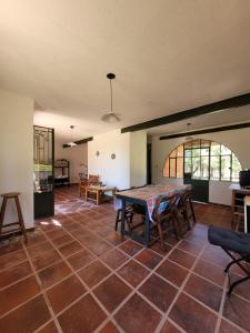 a living room with a table and a room with a floor at Casas de Campo in Santa María