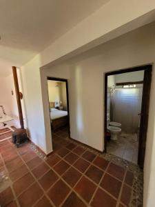 a room with a bathroom with a toilet and a bedroom at Casas de Campo in Santa María