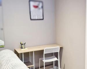 a desk in a bedroom with a bed and a chair at Stylish & modern studio in Burnley in Burnley
