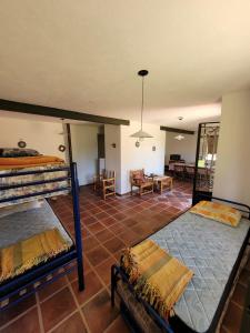 a bedroom with two bunk beds and a living room at Casas de Campo in Santa María