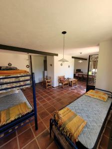 a bedroom with two bunk beds and a living room at Casona y Casa de Campo in Santa María +10 photos