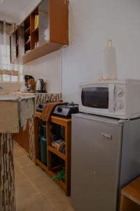 a kitchen with a microwave on top of a refrigerator at Cade Homes 2 in Narok
