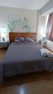 a bedroom with a large bed with two pillows at Miraflores View in Lima