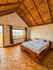 1 dormitorio con 1 cama grande y techo de madera en M beach, 