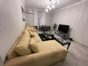 a living room with a couch and a table at Fully furnished family house in Al Madinah