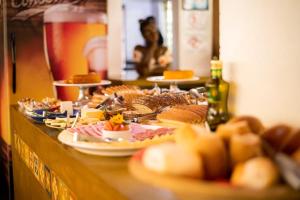 - un buffet avec différents types de nourriture dans l'établissement Pousada da Mata, à Cunha