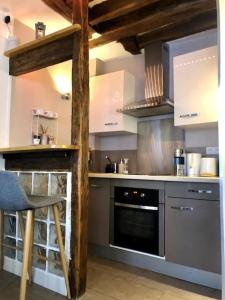 a kitchen with stainless steel appliances and a stove at Appartement au cœur de Paris /quartier Montorgueil in Paris