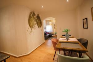 a dining room with a table and chairs in a room at Moselzauber Güls in Koblenz