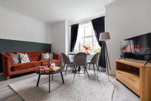 a living room with a red couch and a table at Stylish & Spacious 3bed in Putney in London
