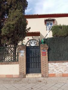 una puerta negra en una casa con una valla en El Diez de Sultana en Granada
