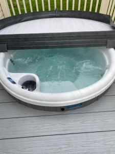 a hot tub with a bed on a wooden deck at KINGFISHER COURT 2 Tattershall lakes with hot tub in Tattershall