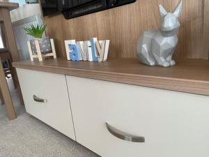 a wooden counter top with a cat statue on it at KINGFISHER COURT 2 Tattershall lakes with hot tub in Tattershall