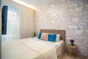 a bedroom with a bed and a wall with birds at LaVida Deluxe villa Hajdúszoboszló in Hajdúszoboszló +29 photos