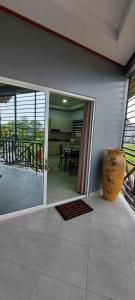 a room with a patio with a table and a vase at V3 appartement in Paramaribo