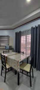 a dining room with a table and two chairs at V3 appartement in Paramaribo
