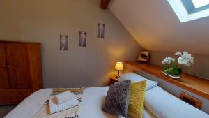 a bedroom with a white bed and a window at Cader Mountain View Cottage with Hot Tub in Snowdonia in Dolgellau