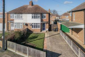 an aerial view of a house with a fence at Stylishly Decorated 3-bed House in Bedford