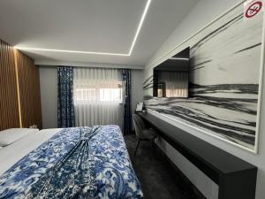 a hotel room with a bed and a desk at Luxury Room 's in Velika Kladuša
