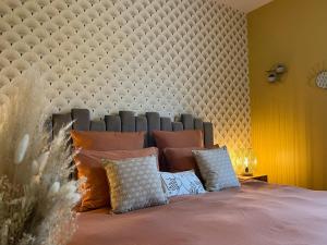 a bed with a large padded headboard and pillows at Les Chenes Rouges in Veyrines-de-Domme +41 photos