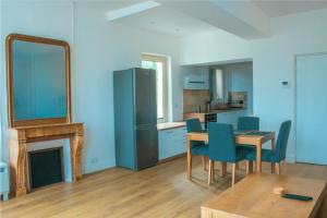 a kitchen with a table and chairs and a mirror at Grand 2P vue seine in Mantes-la-Jolie