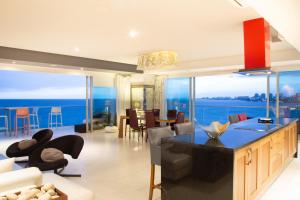 a kitchen and living room with a view of the ocean at Luxury Condo Peninsula in Puerto Vallarta