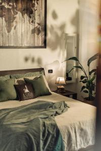 a bedroom with a bed and a lamp and a plant at A Casa dello Steno - Unicità Rustica in Bologna