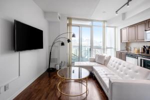 a living room with a white couch and a table at DownTown Toronto luxury condo in Toronto