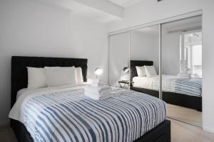 a bedroom with a large bed and a mirror at DownTown Toronto luxury condo in Toronto
